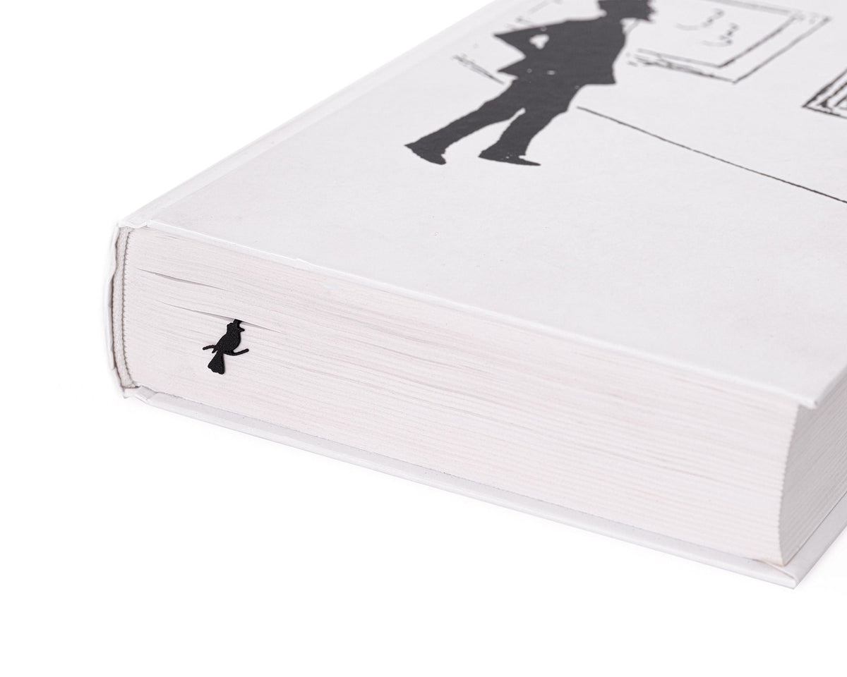 Cats Tightrope Walkers metal bookmark in a closed book, only its top showing above the pages