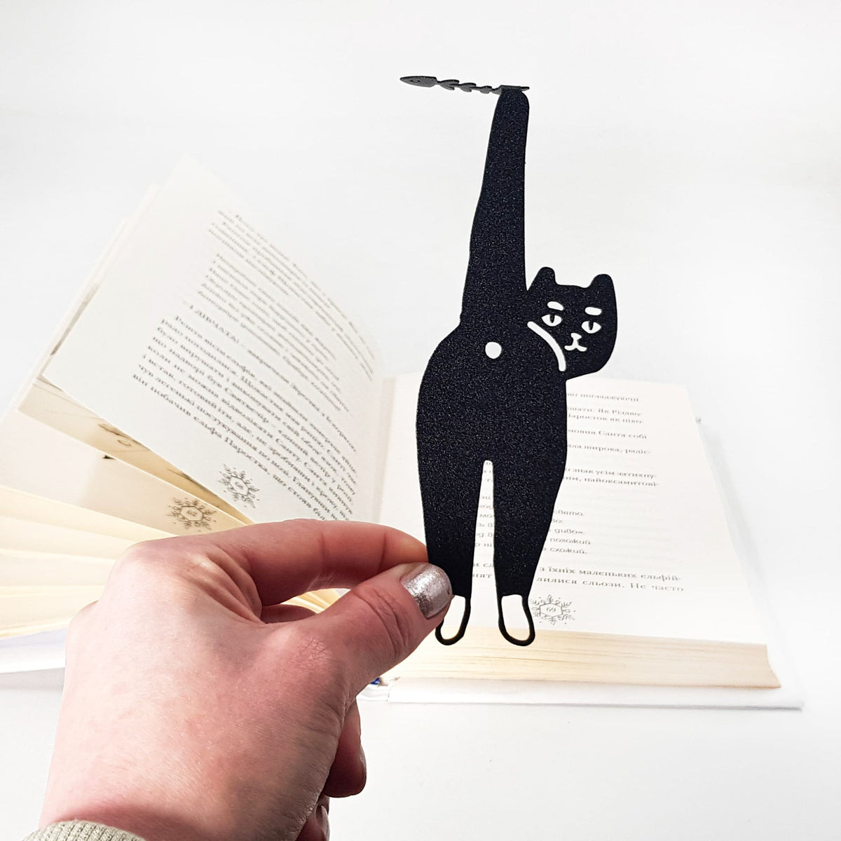 Cheeky Black Cat book marker on an illustrated page