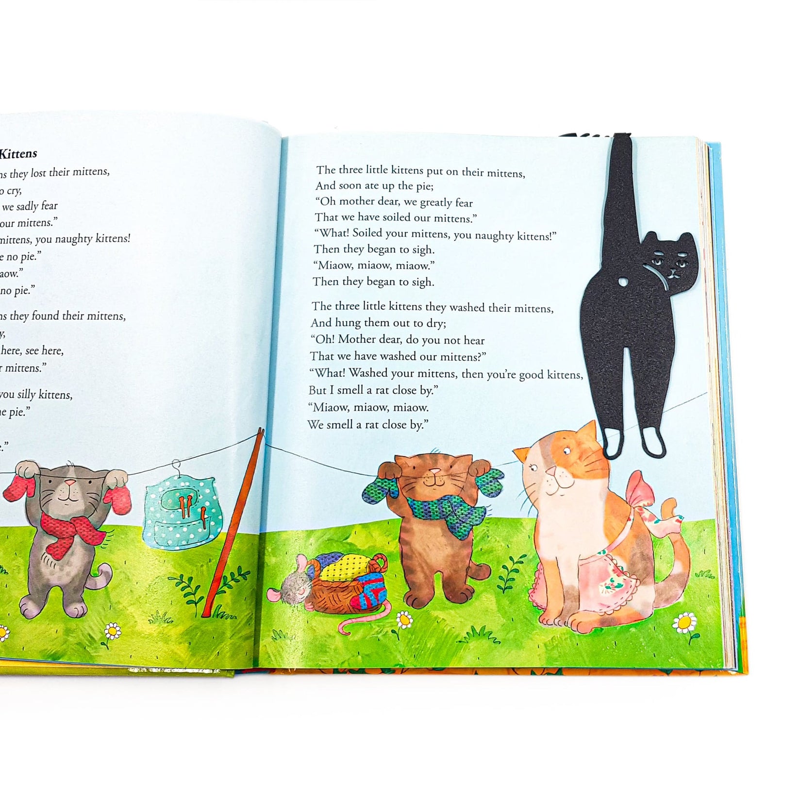 Cheeky Black Cat book marker placed on a colour illustration