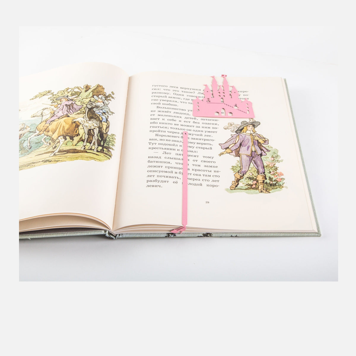 Cinderella's Slipper metal bookmark in red marking a page in an illustrated book
