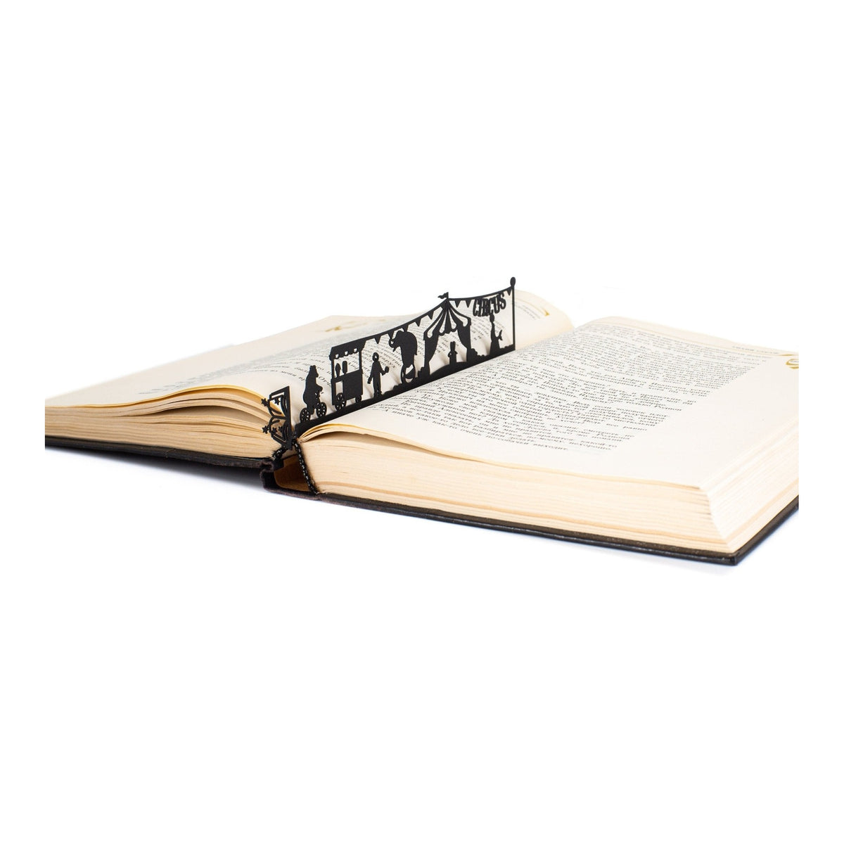 Circus metal bookmark resting on the pages of an open book