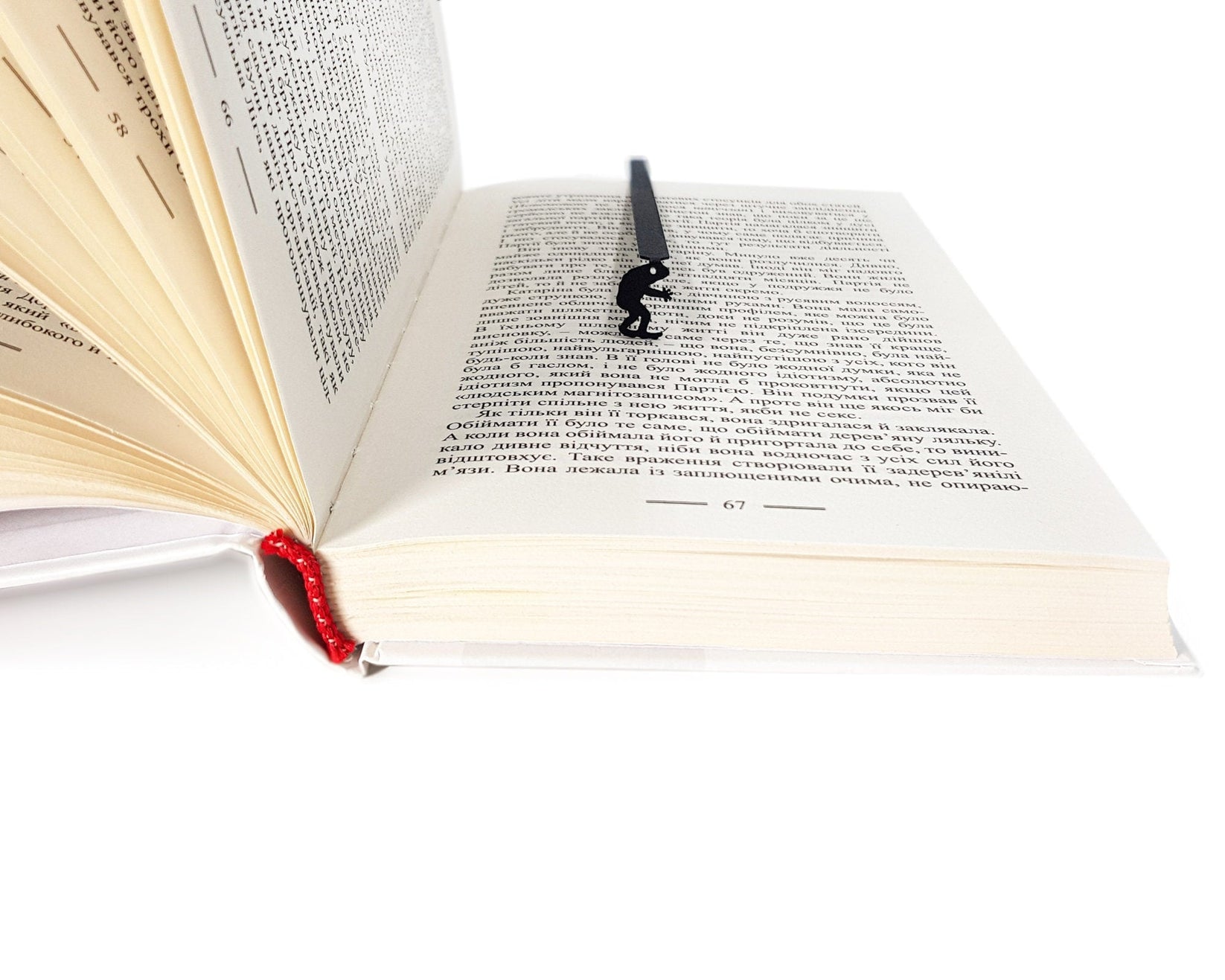Frogman metal bookmark lying across the pages of an open book