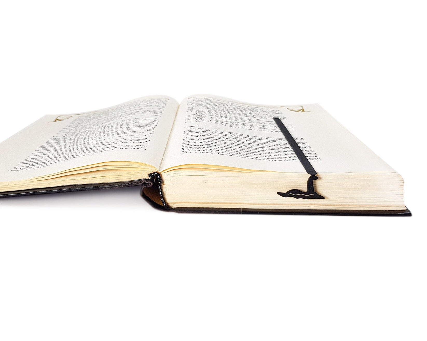 Loch Ness metal bookmark marking a page in an open book