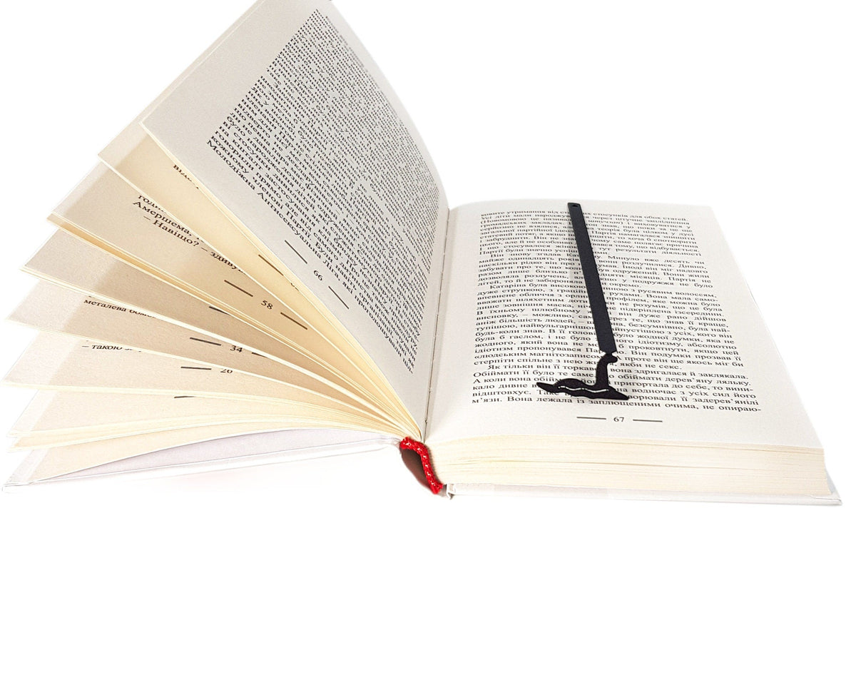 Loch Ness metal bookmark resting on the pages of an open book
