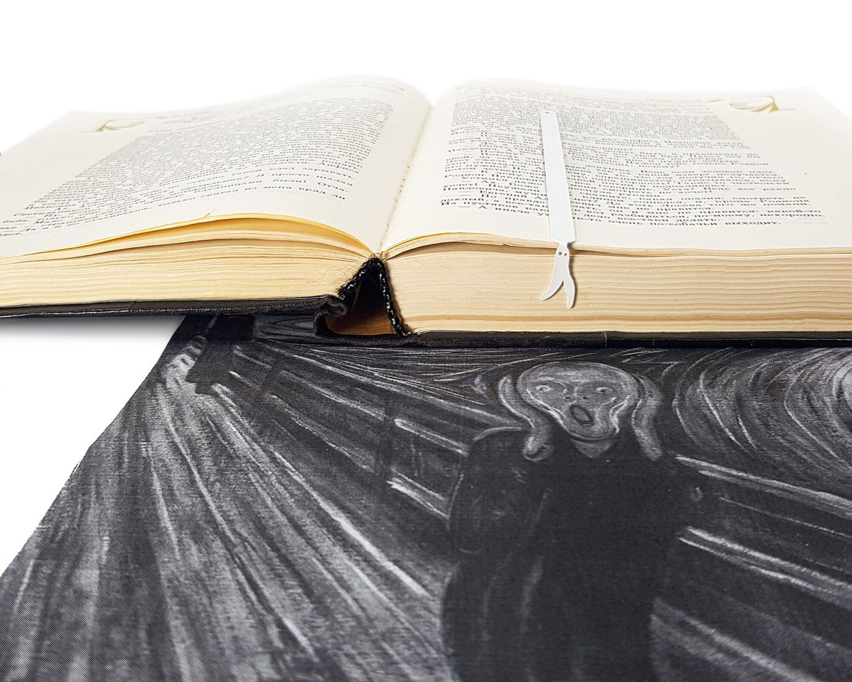 Nightcrawler metal bookmark in white on an illustrated page