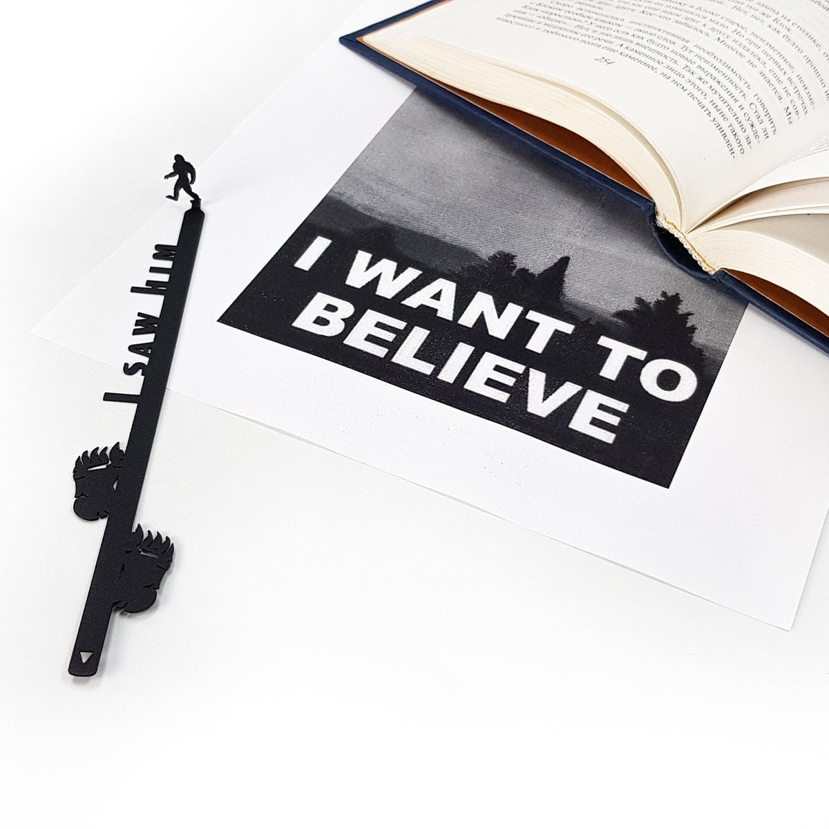 Bigfoot metal bookmark on an illustrated page