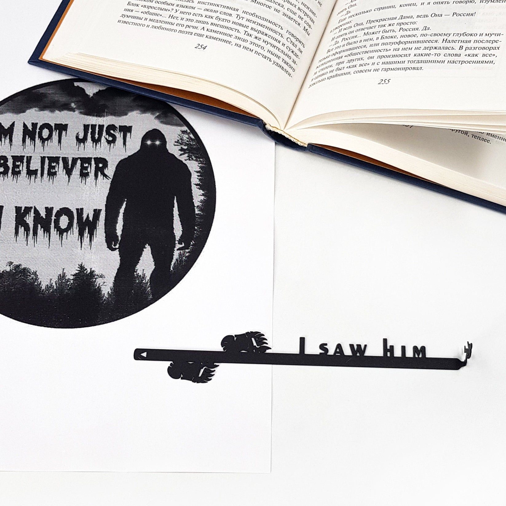 Bigfoot metal bookmark marking a page in an illustrated book