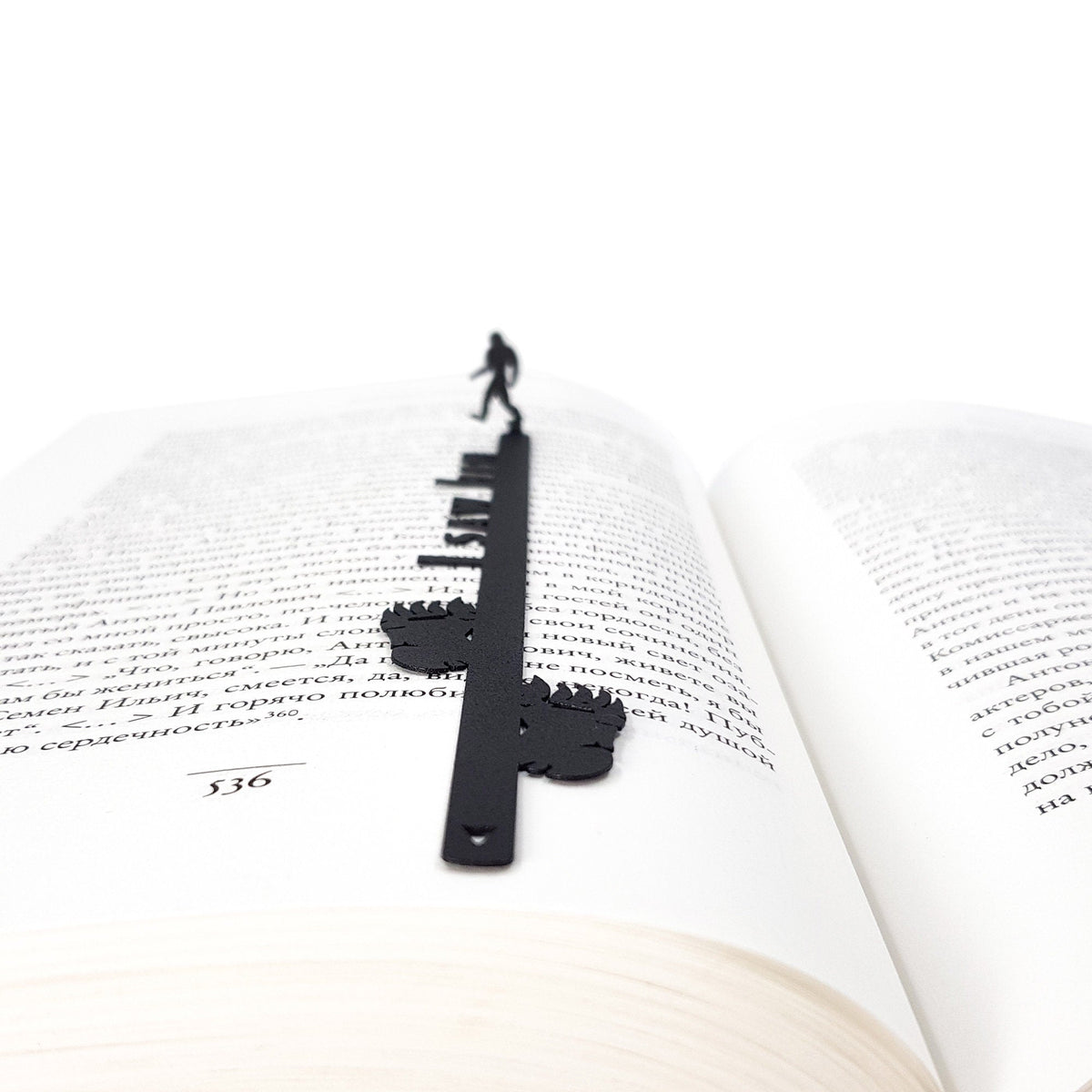 Bigfoot metal bookmark set into the gutter of an open book