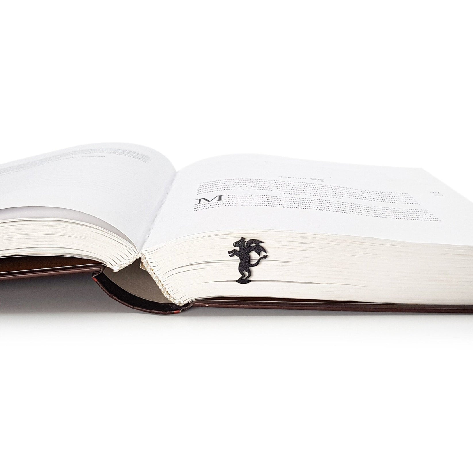 Monster Jersey Devil metal bookmark set into the gutter of an open book