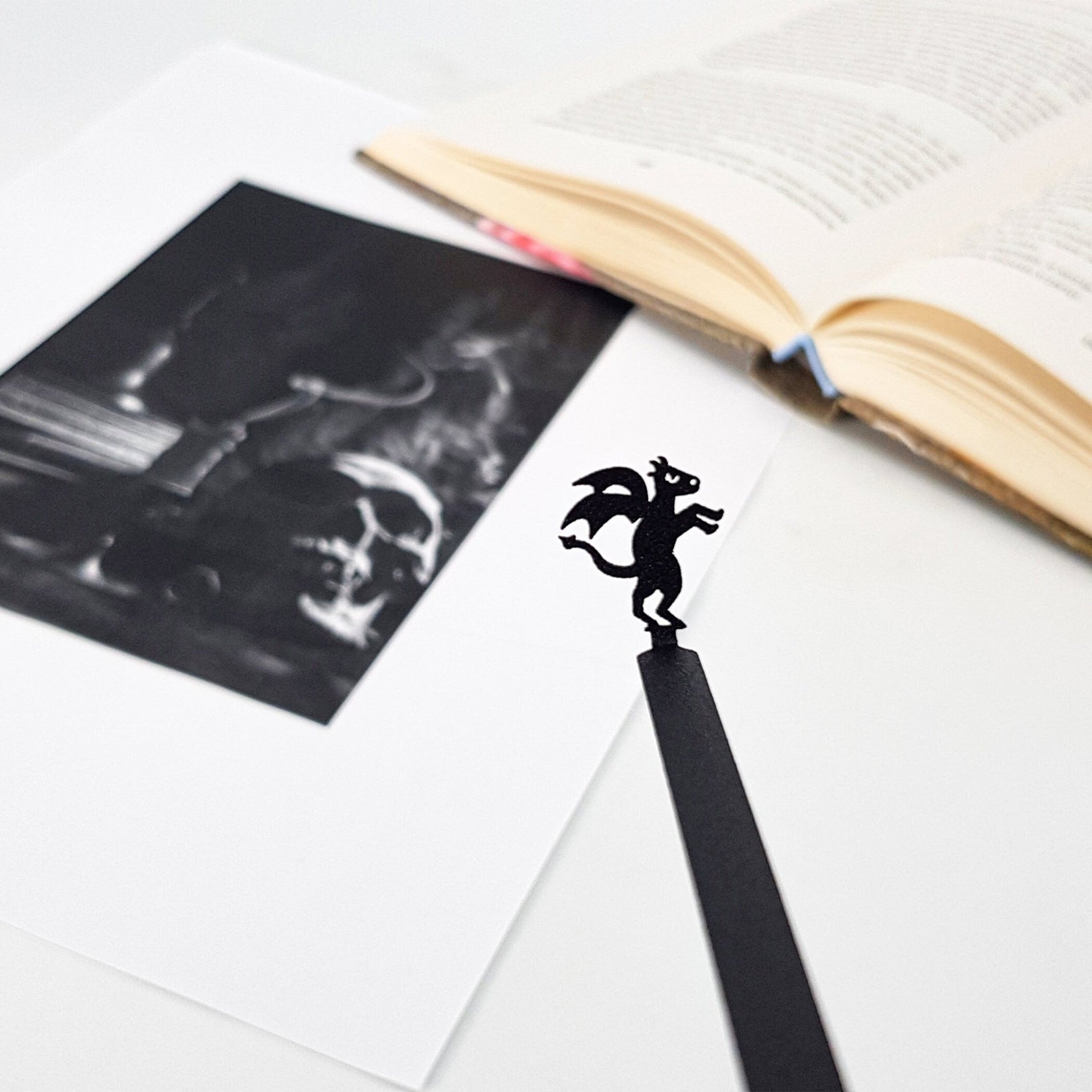 Monster Jersey Devil metal bookmark marking a page in an illustrated book