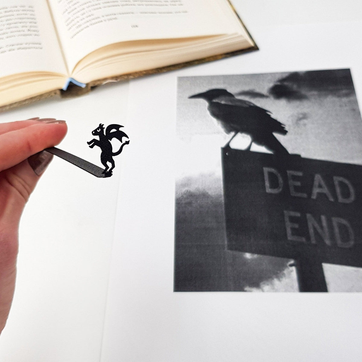 Monster Jersey Devil metal bookmark held in a hand to show its size
