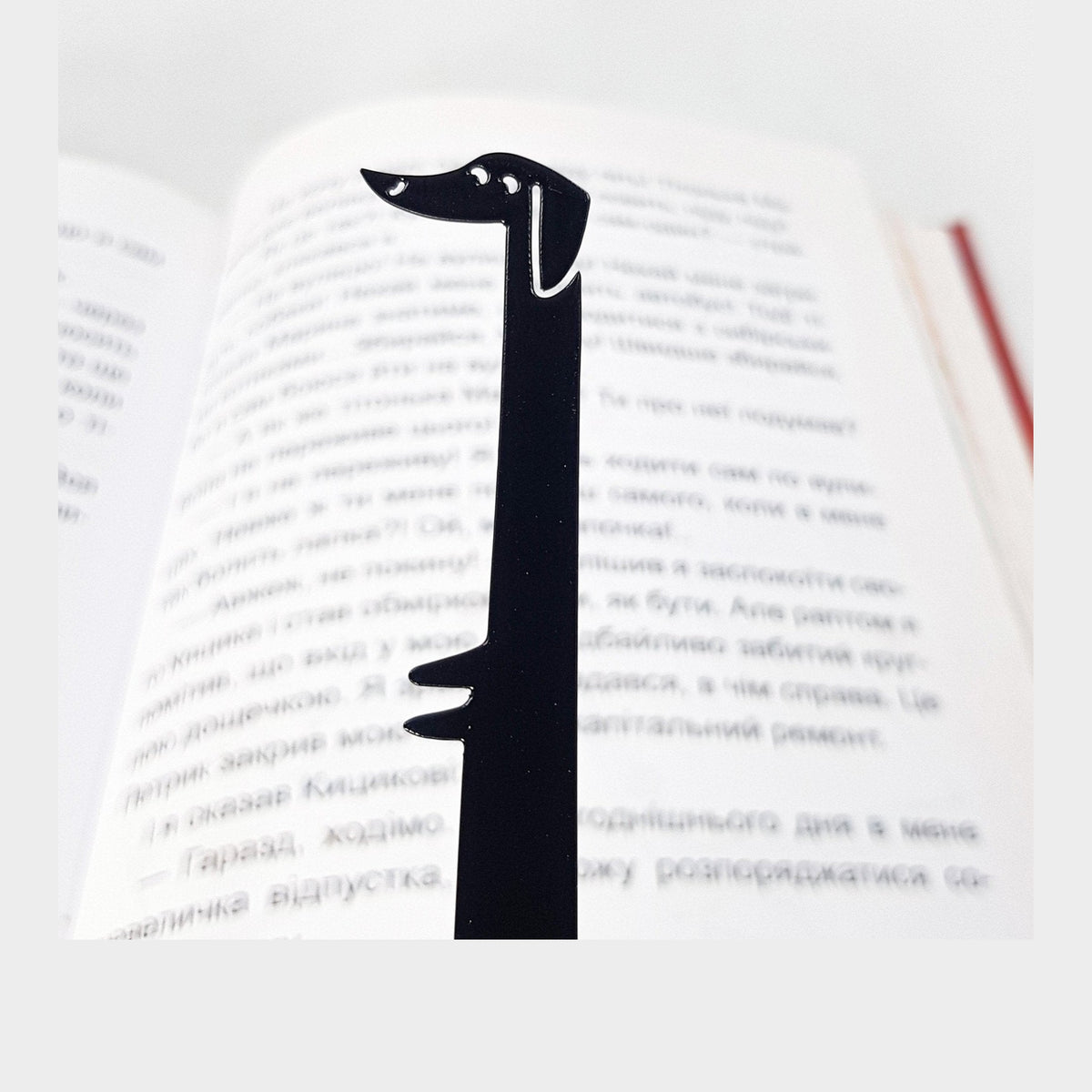 Dachshund My Long Time Friend metal bookmark resting on the pages of an open book