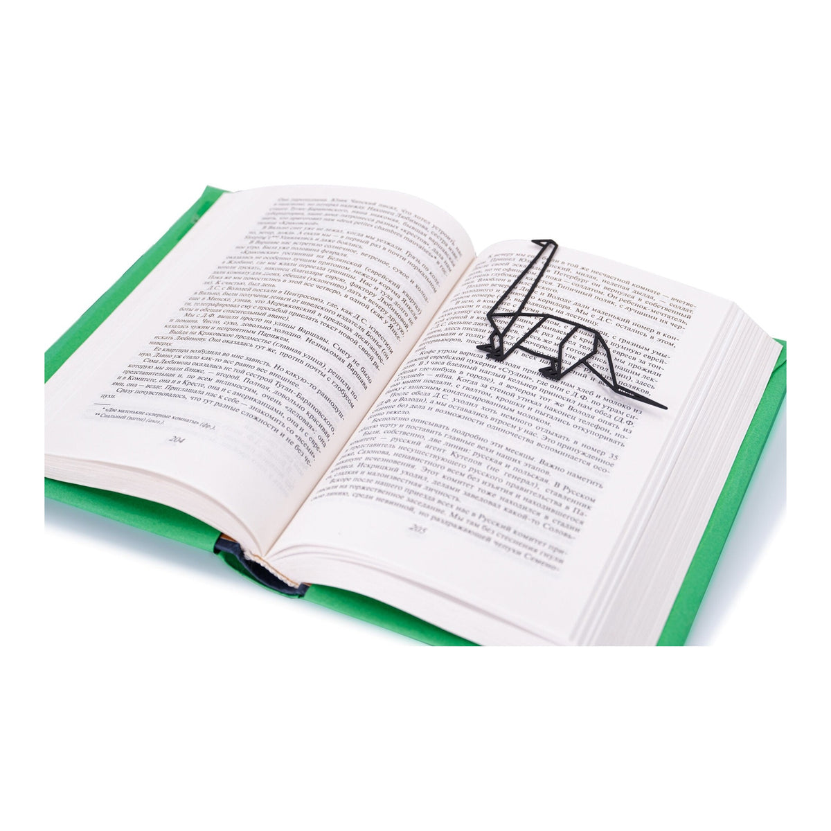 Dinosaur Geometry Style metal bookmark resting on the pages of an open book