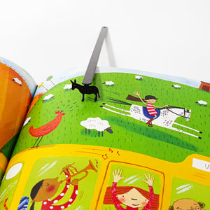 Black metal donkey bookmark inside open colorful children's picture book, top view