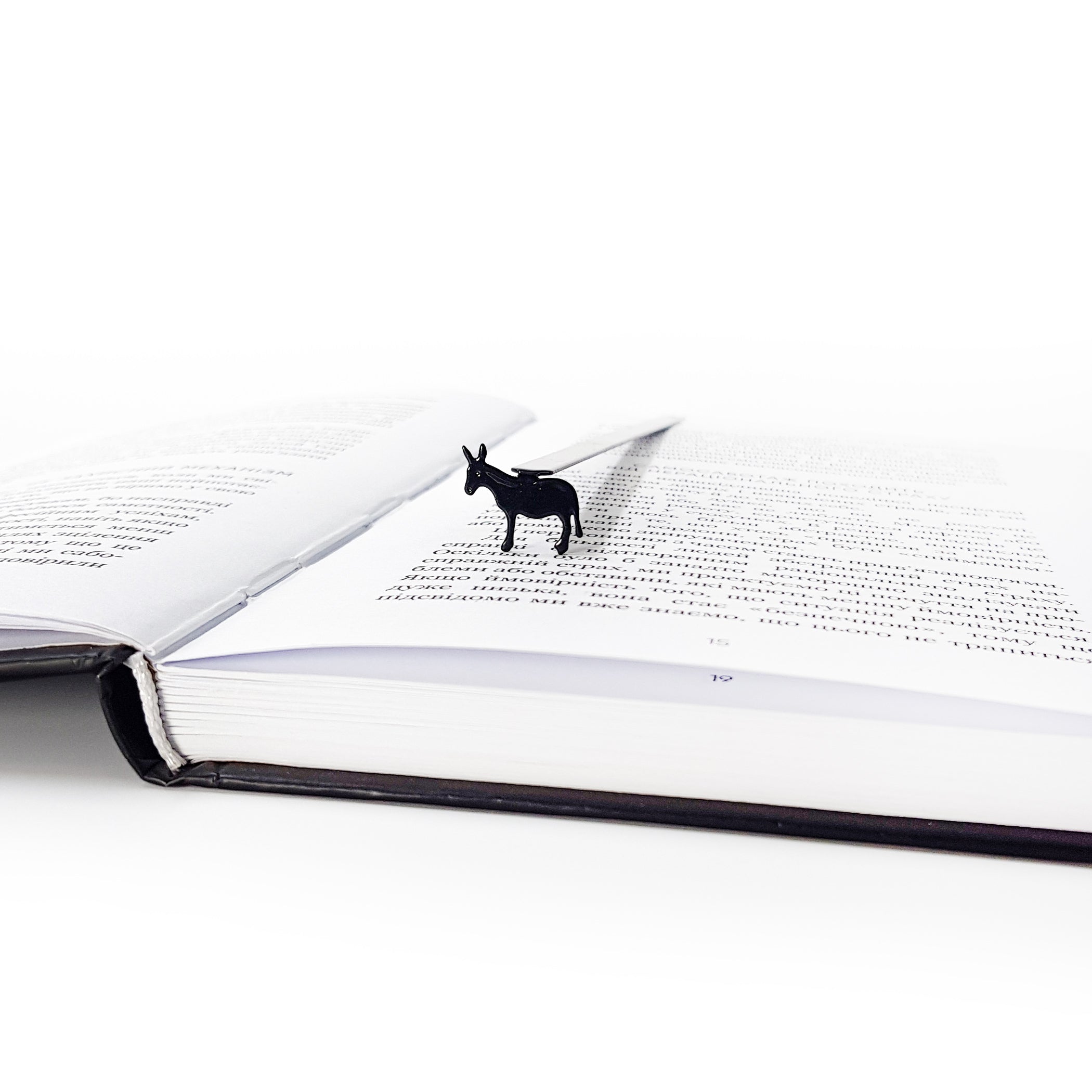 Close-up of black steel donkey bookmark on white background showing full powder-coated silhouette
