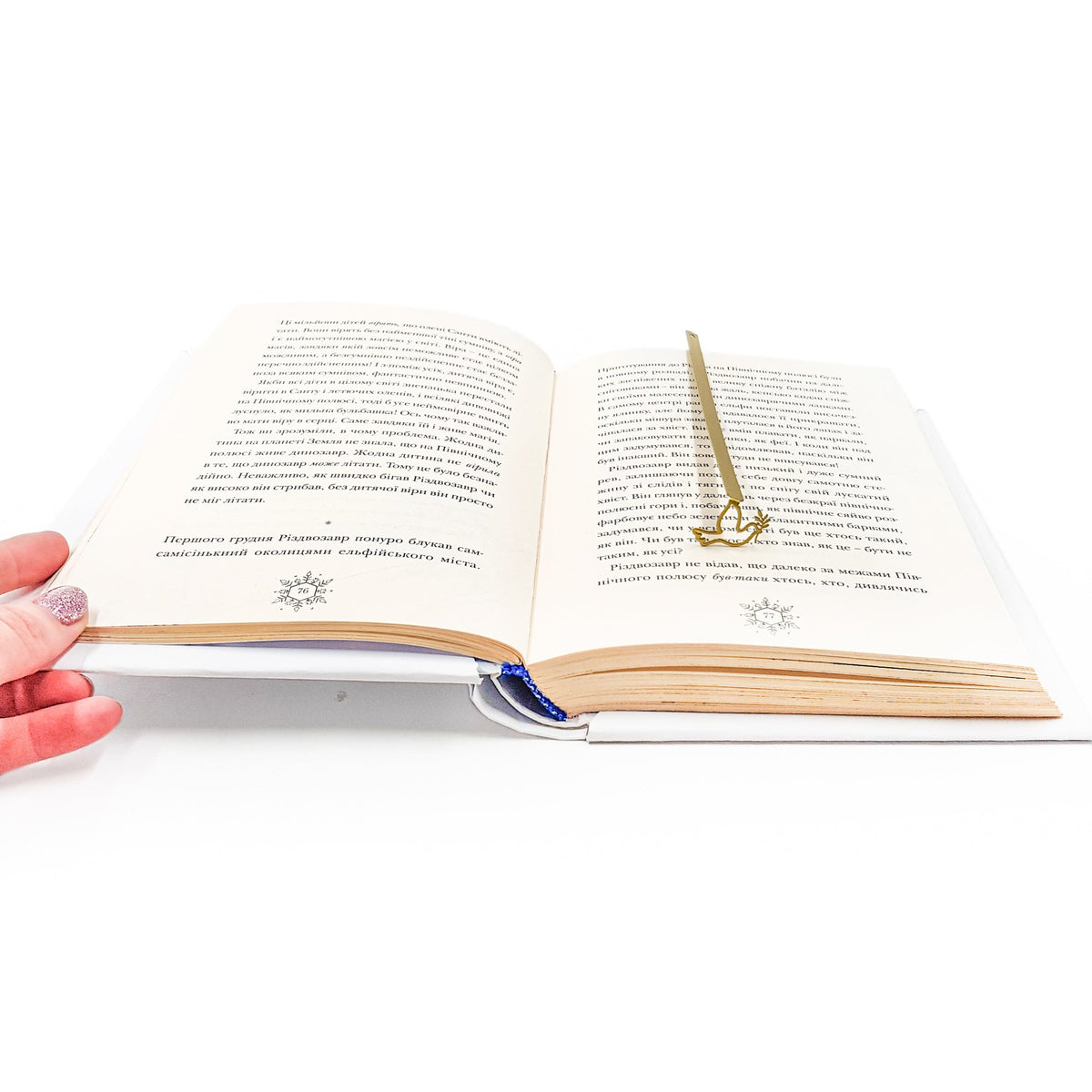 Dove of Peace metal bookmark in gold resting on the pages of an open book, view 5