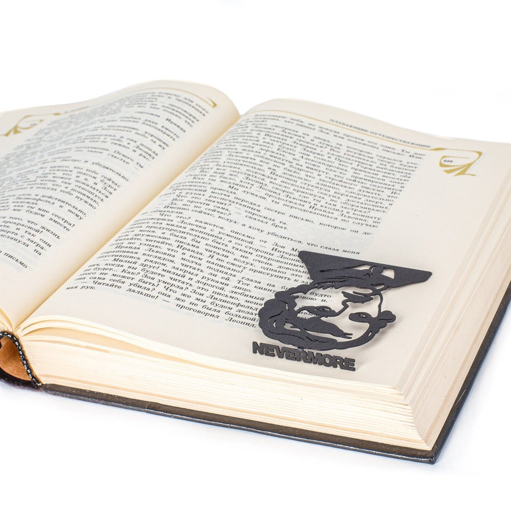 Edgar Allan Poe metal bookmark marking a page in an open book