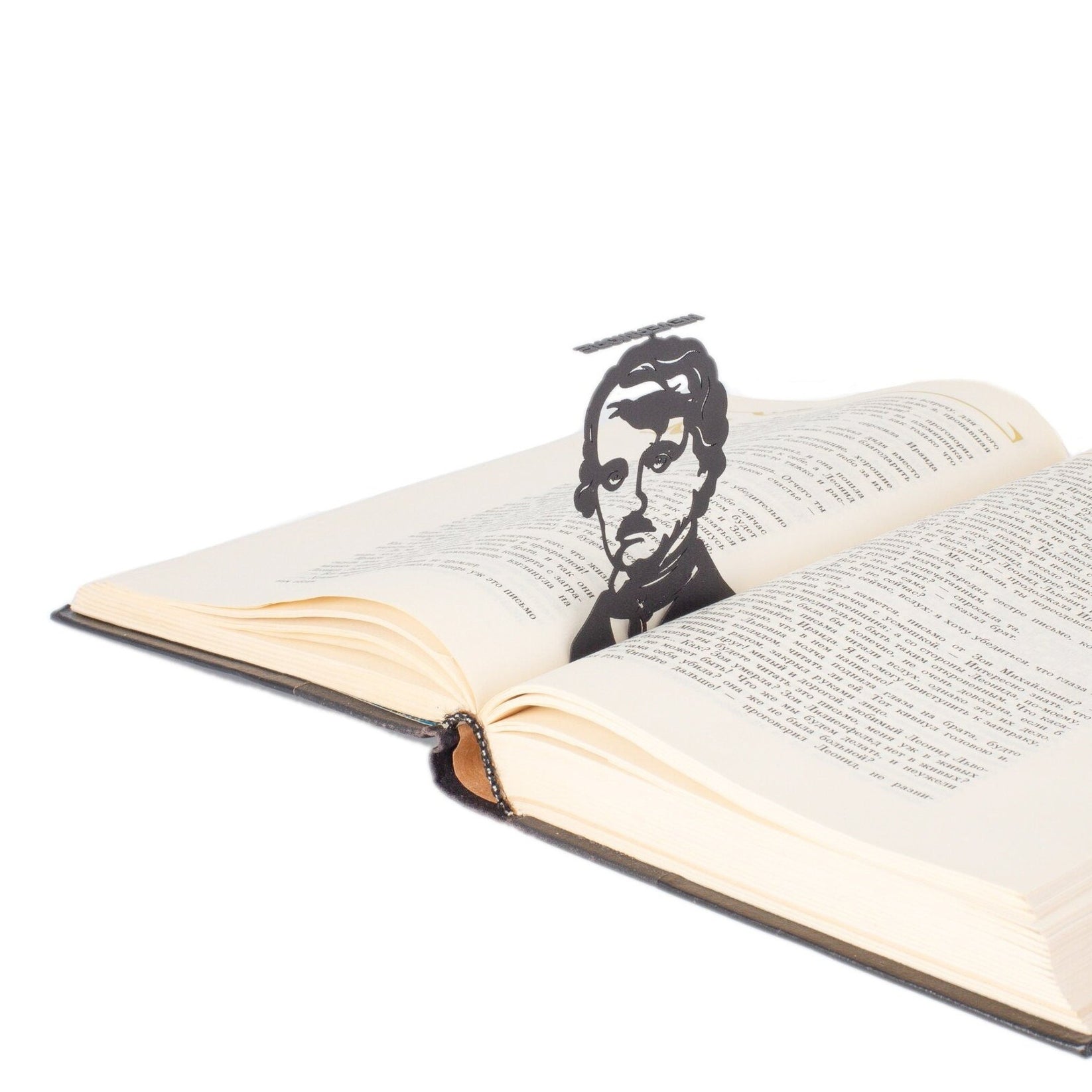 Edgar Allan Poe metal bookmark resting on the pages of an open book