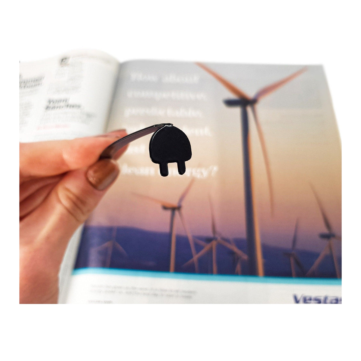 Electrical Plug metal bookmark marking a page in an illustrated book