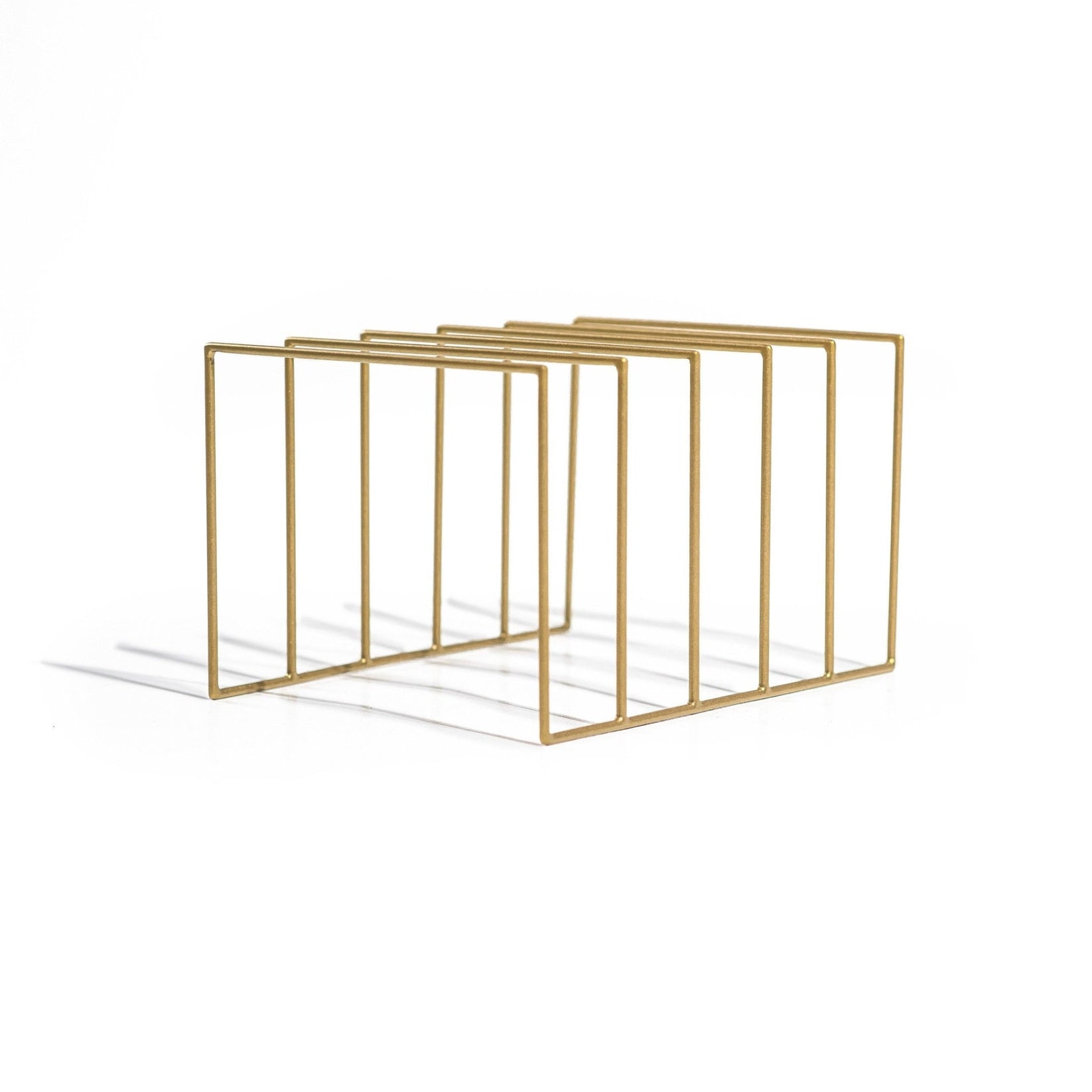 Modern gold metal vinyl record holder featuring five sleek open compartments. The geometric wireframe design adds a touch of elegance and minimalism, styled against a clean white background.