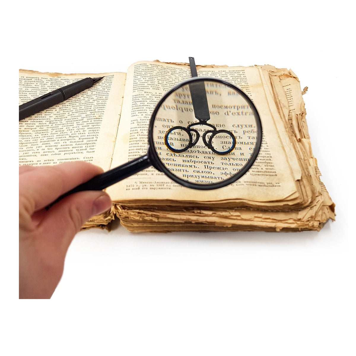 Eyeglasses Pince-Nez metal bookmark held in a hand above an open book