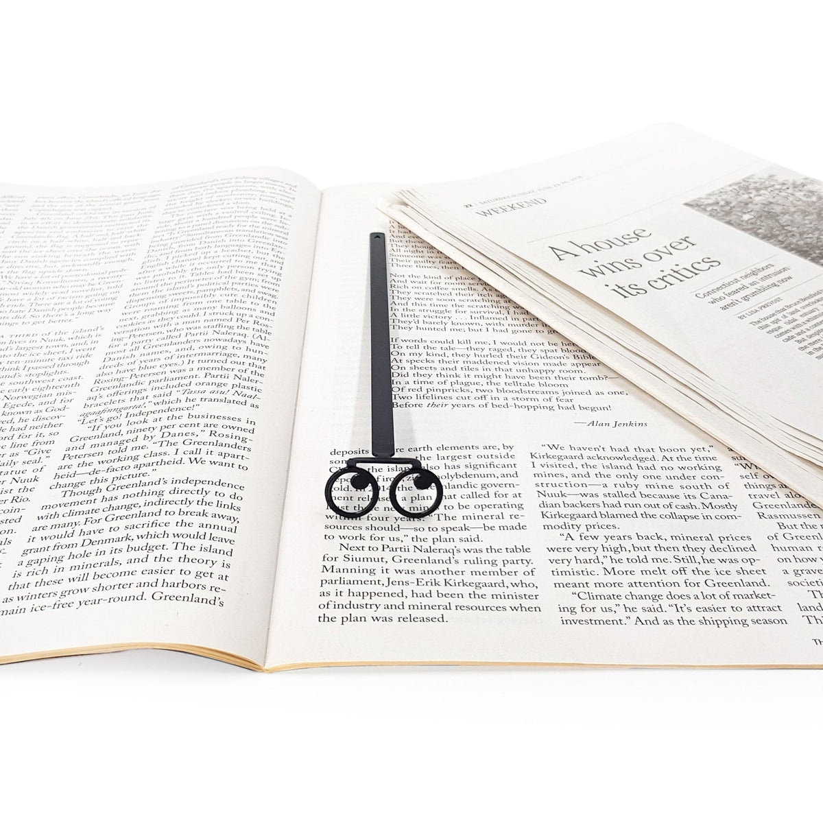 Eyes Glasses metal bookmark resting on the pages of an open book