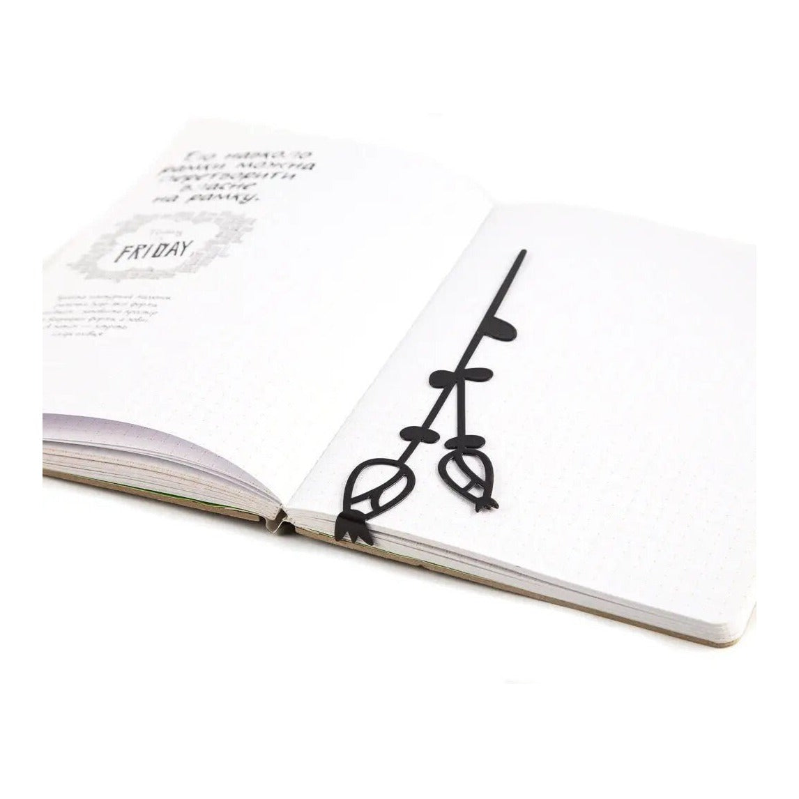 Field Flowers metal bookmark resting on the pages of an open book