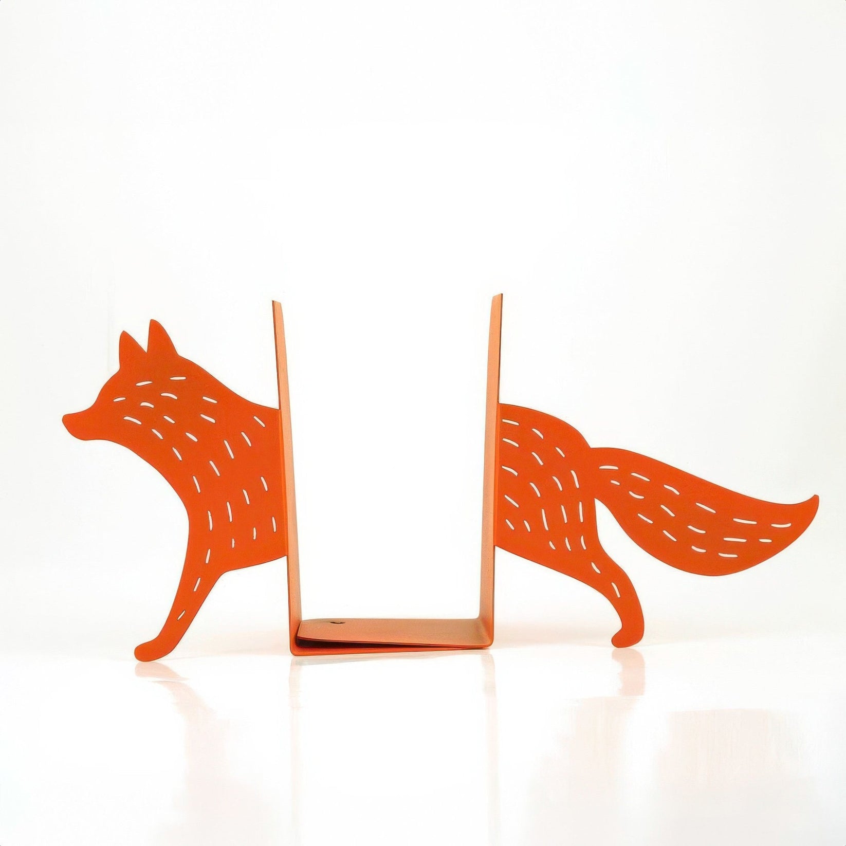 Pair of orange fox metal bookends on a light background