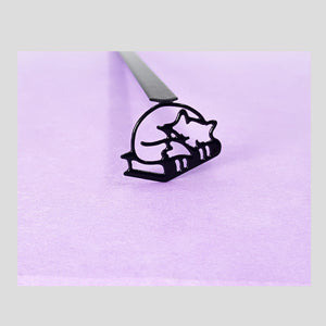 Fox Sleeping on the Books metal bookmark on a coloured background