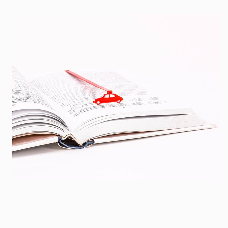 French Car metal bookmark in red resting on the pages of an open book