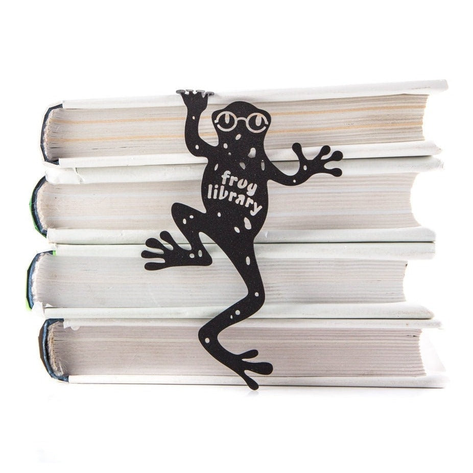 Frog Library metal bookmark shown with a stack of books