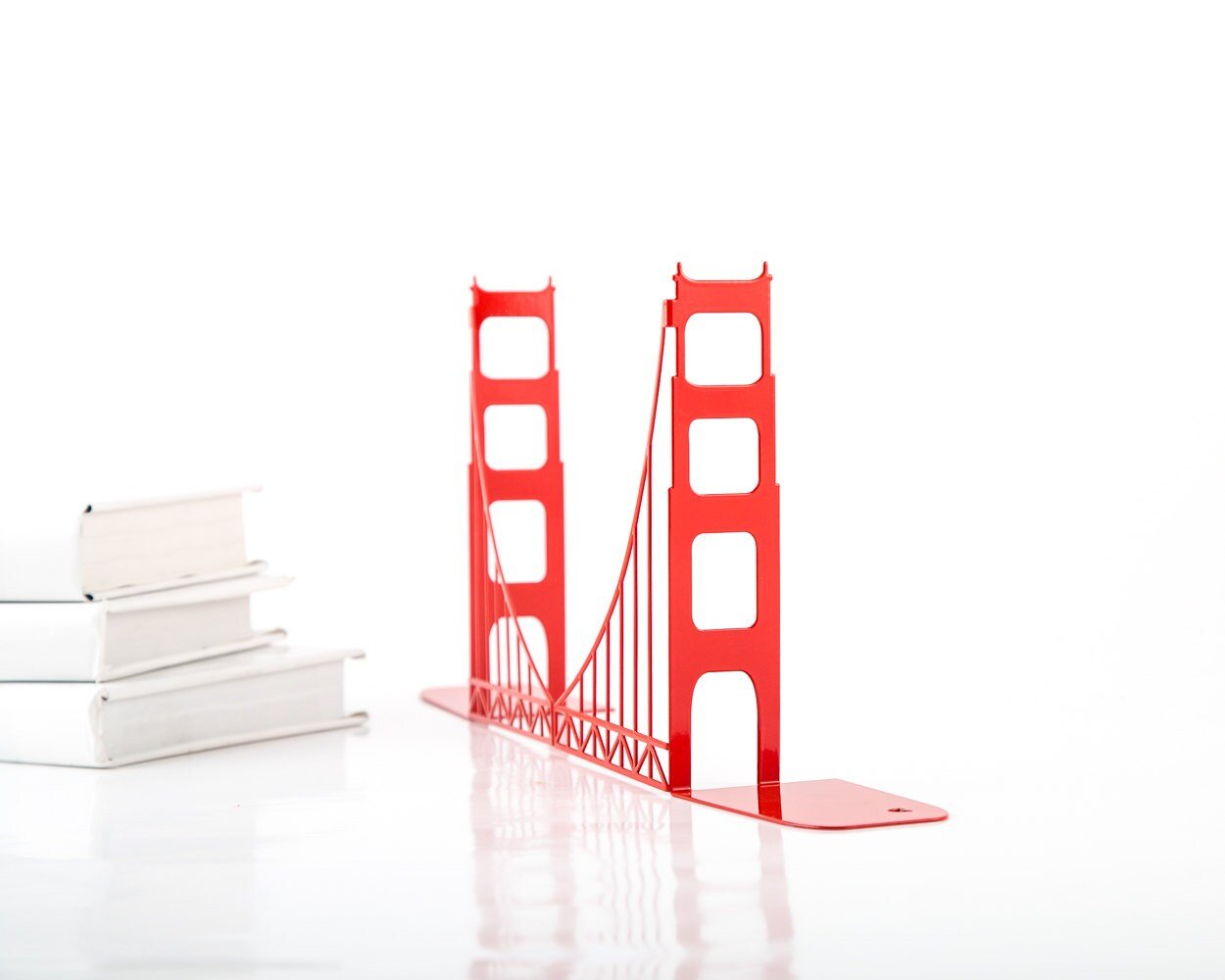 Red Golden Gate Bridge metal bookends shown without books