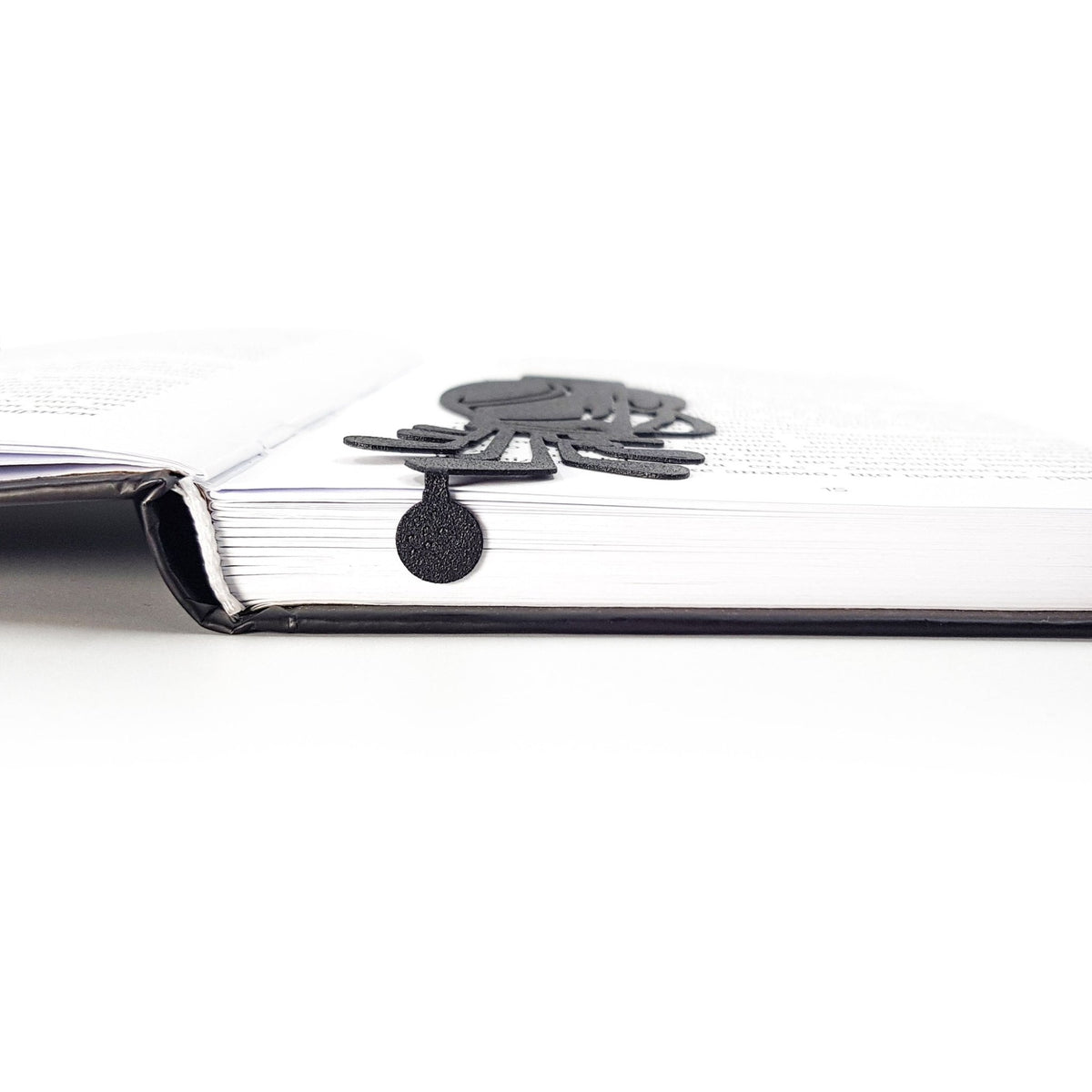 Golf Bag metal bookmark in a closed book, only its top showing above the pages