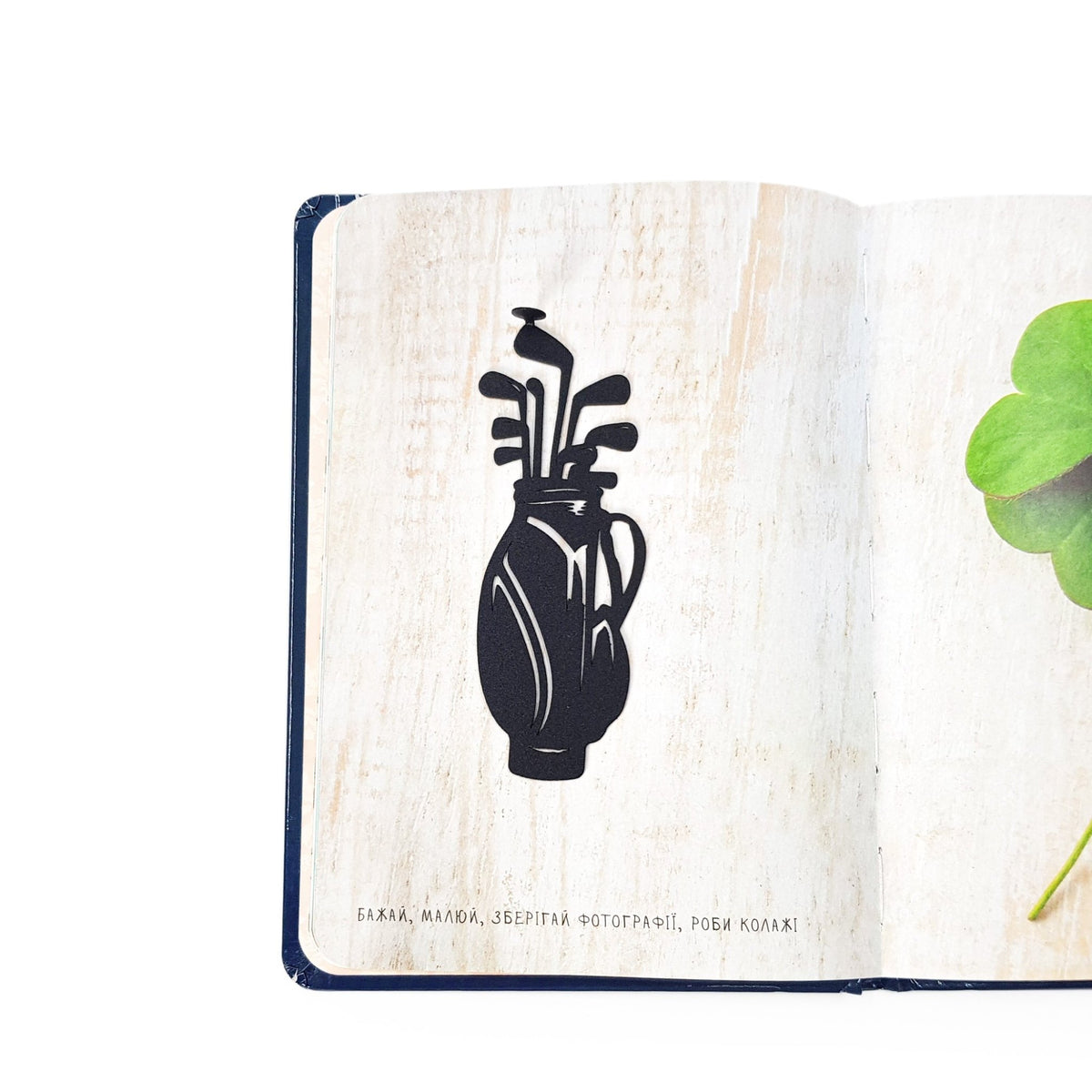 Golf Bag metal bookmark resting on the pages of an open book