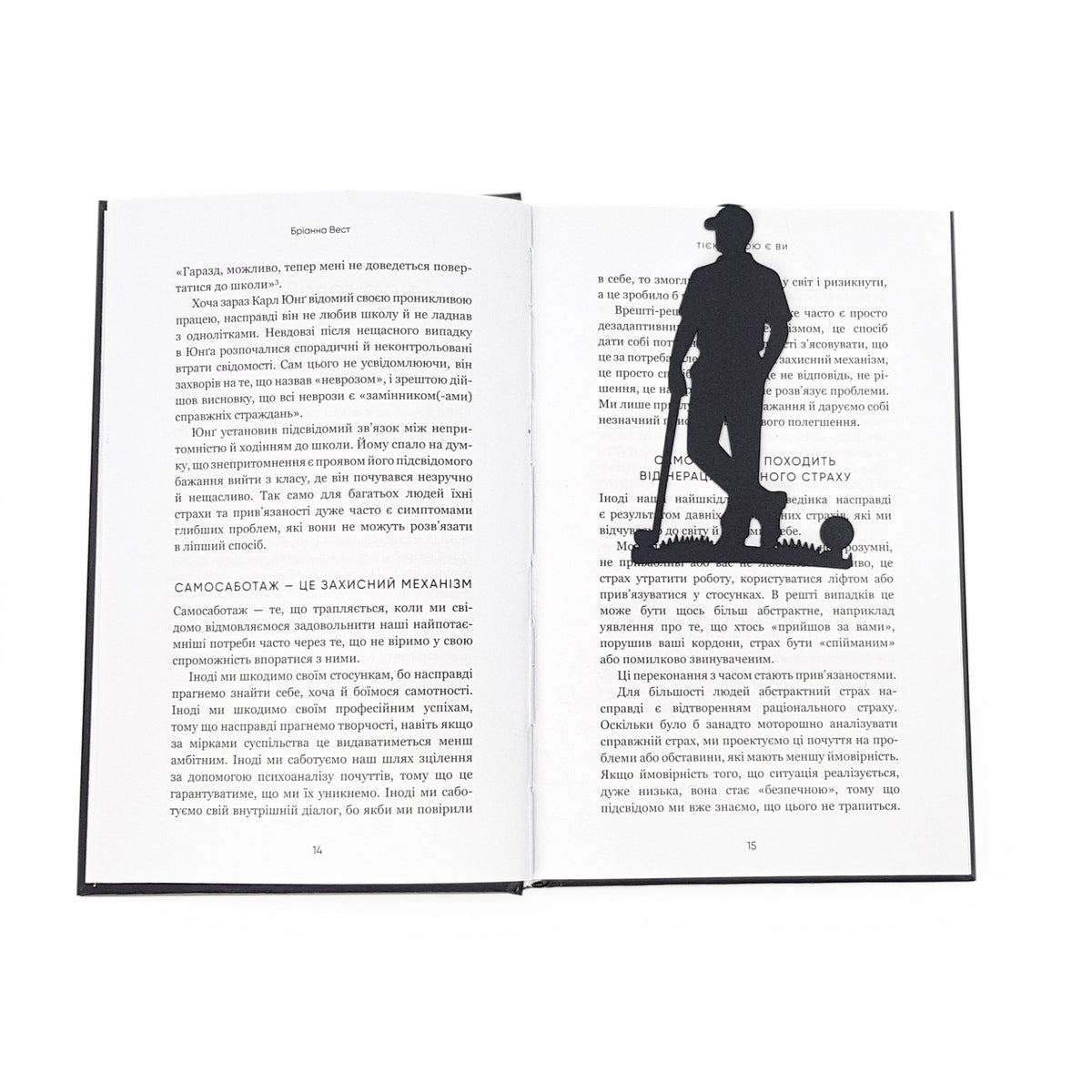 Golf Player metal bookmark resting on the pages of an open book