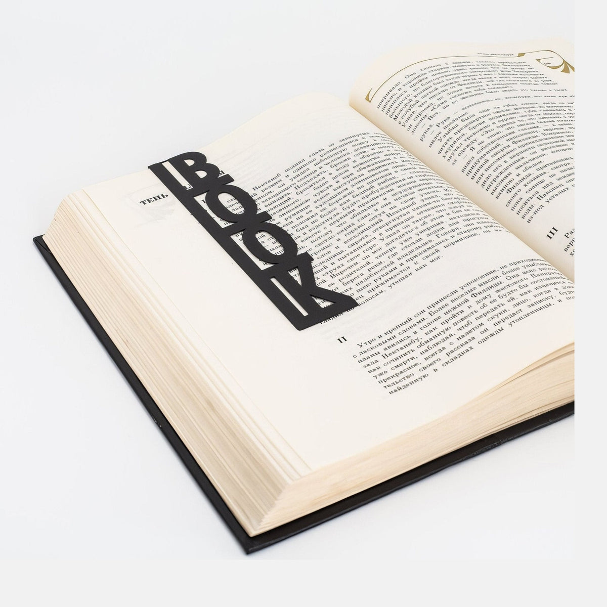 Good Book metal bookmark resting on the pages of an open book