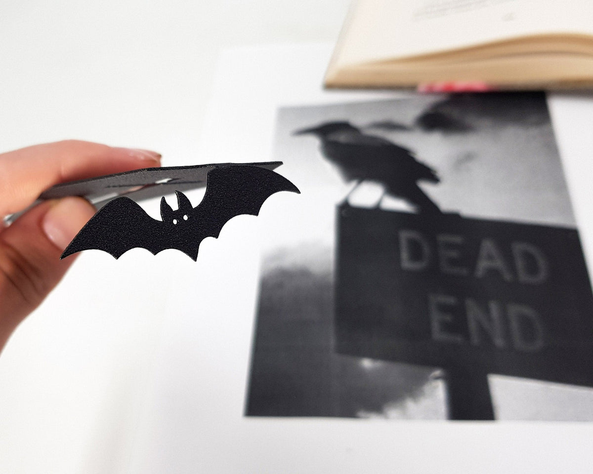 Gothic Coffin in My Book metal bookmark placed on a colour illustration