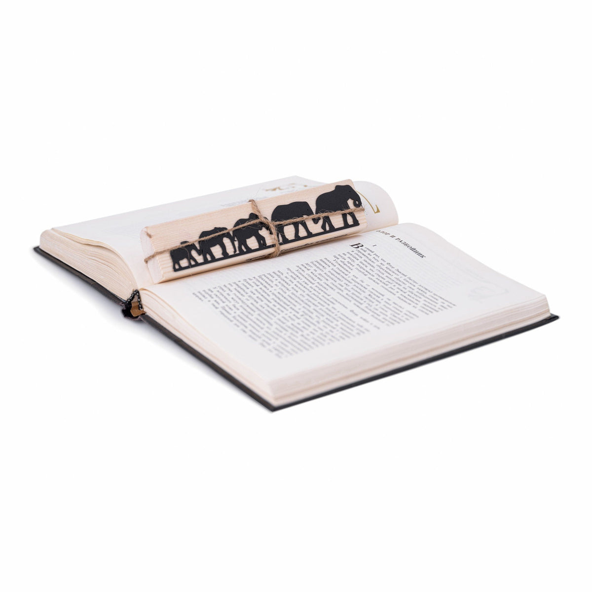 Herd of Elephants metal bookmark resting on the pages of an open book