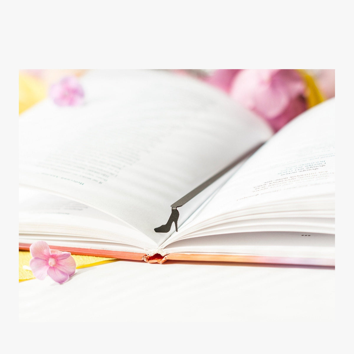 High Heel Shoe metal bookmark resting on the pages of an open book