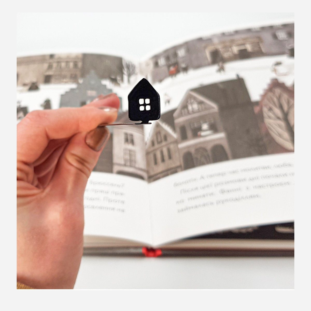 Home Sweet Home metal bookmark marking a page in an illustrated book