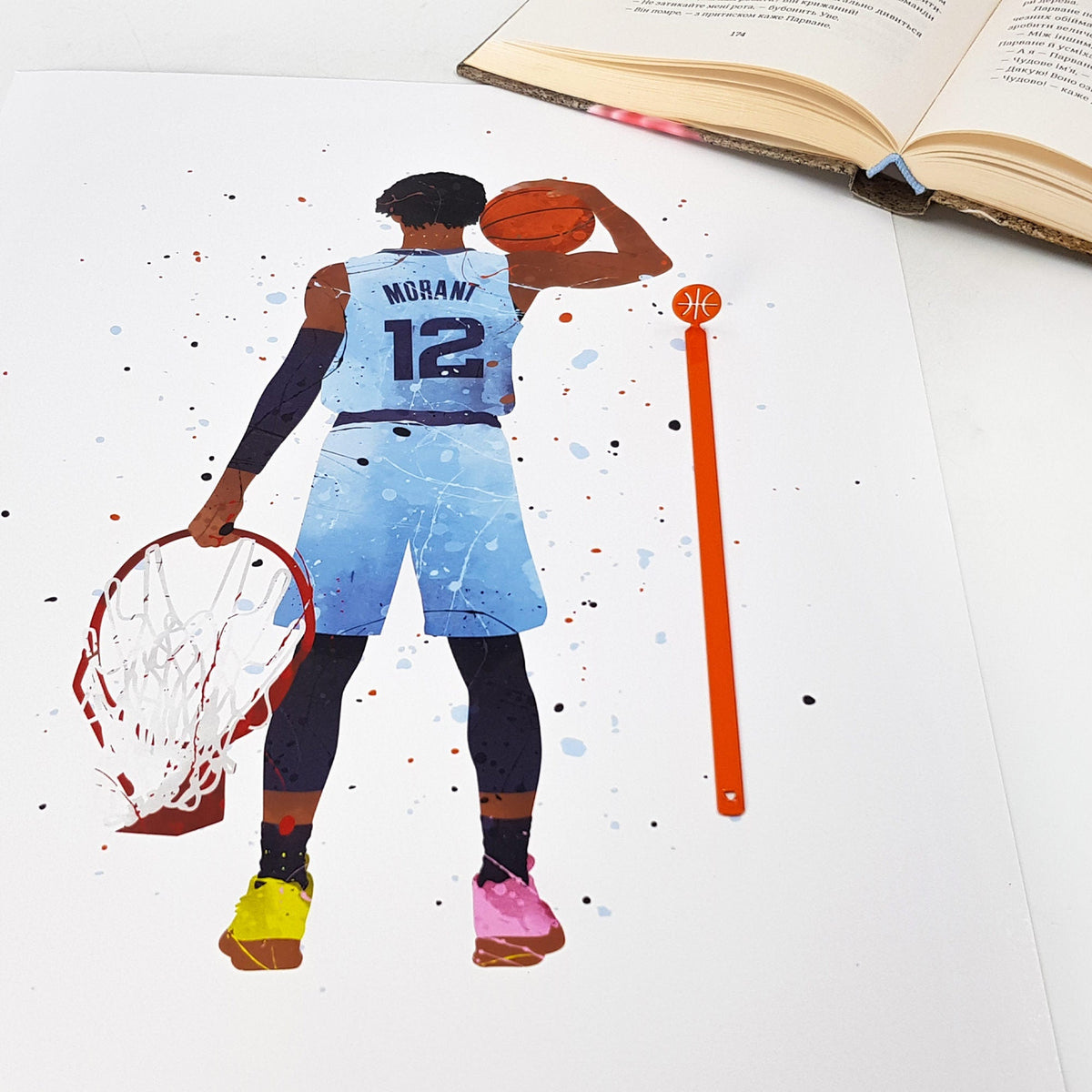 Hoop Dreams Mark metal bookmark in red marking a page in an illustrated book