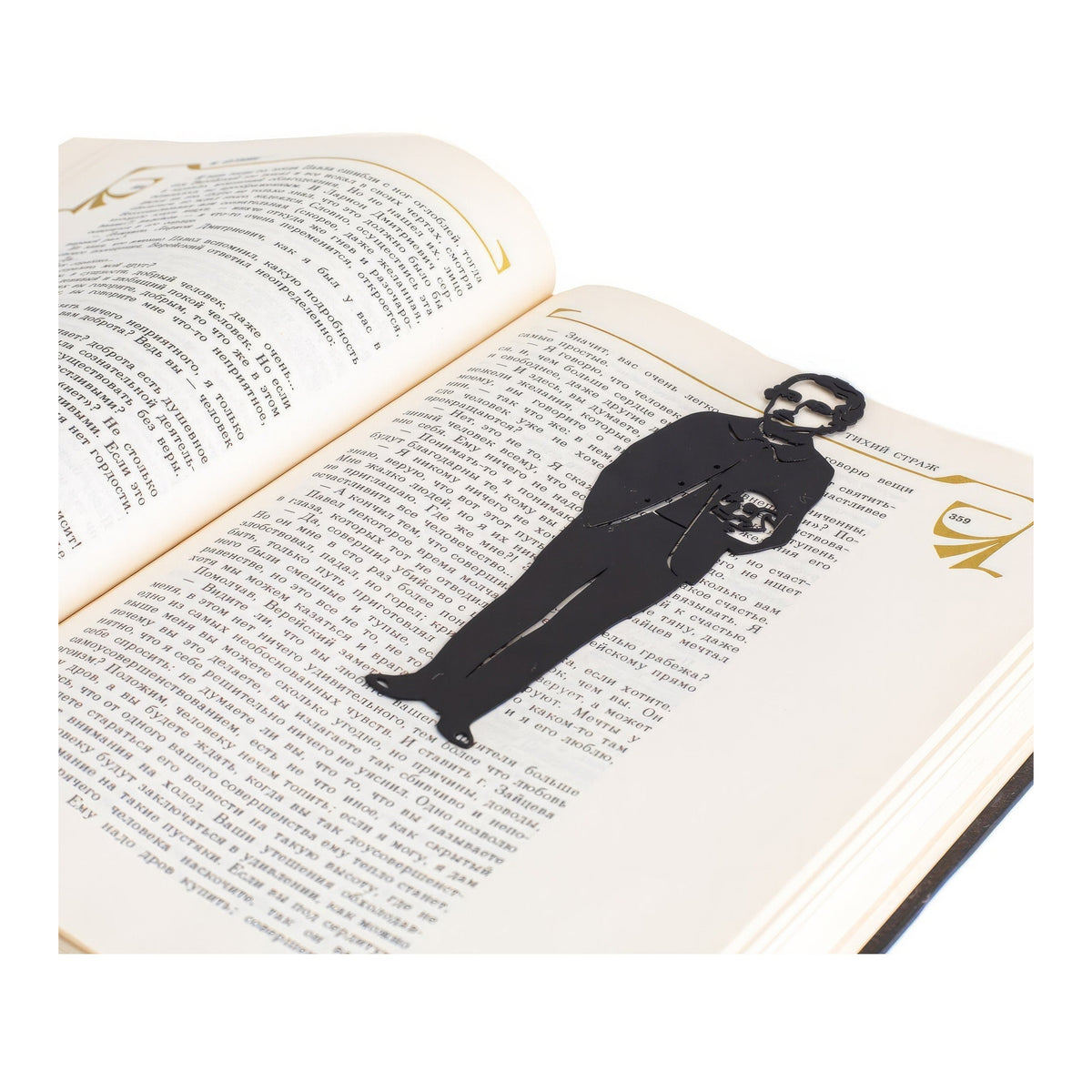Horror Mystery metal bookmark resting on the pages of an open book