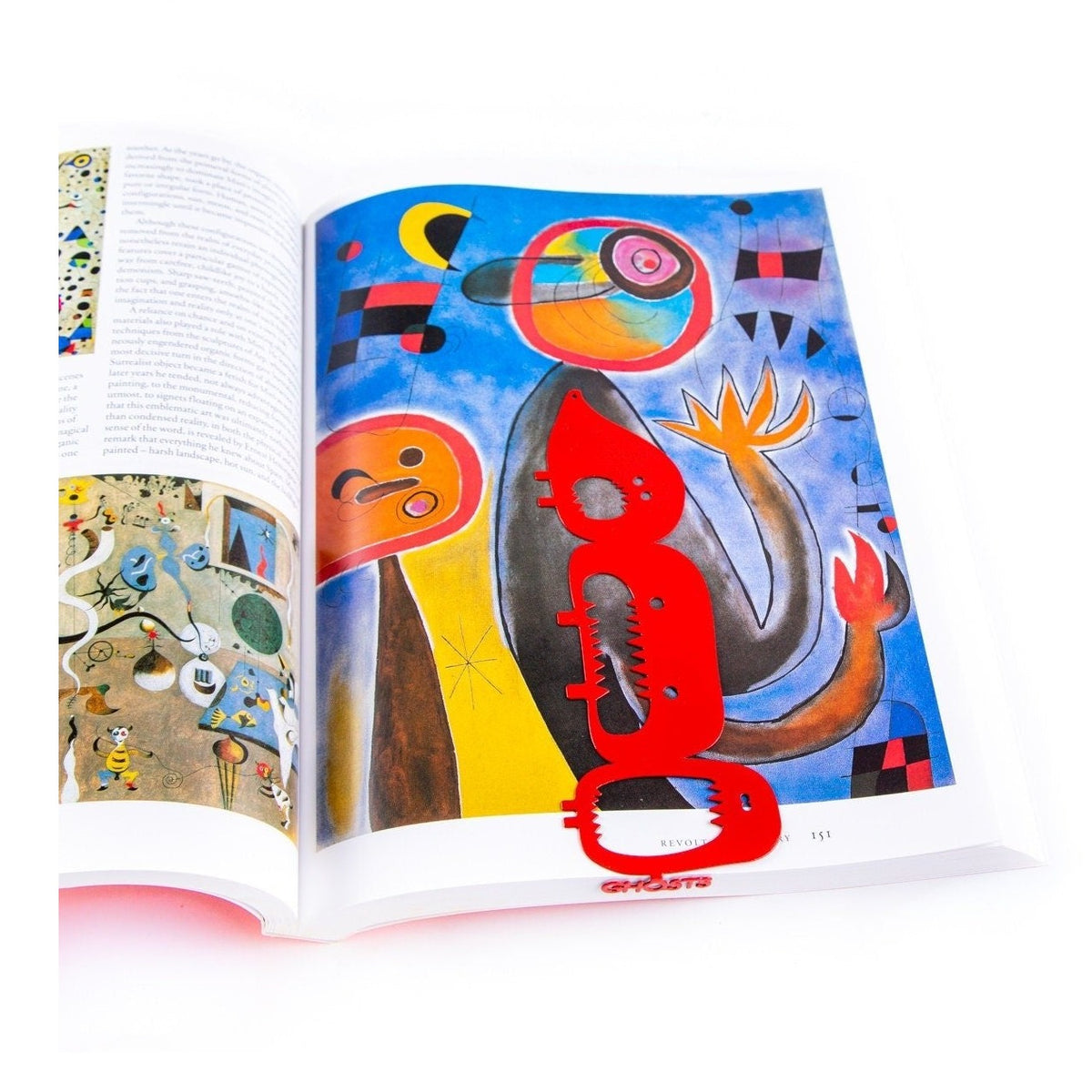 Horror Three Screaming Ghosts metal bookmark in red marking a page in an illustrated book