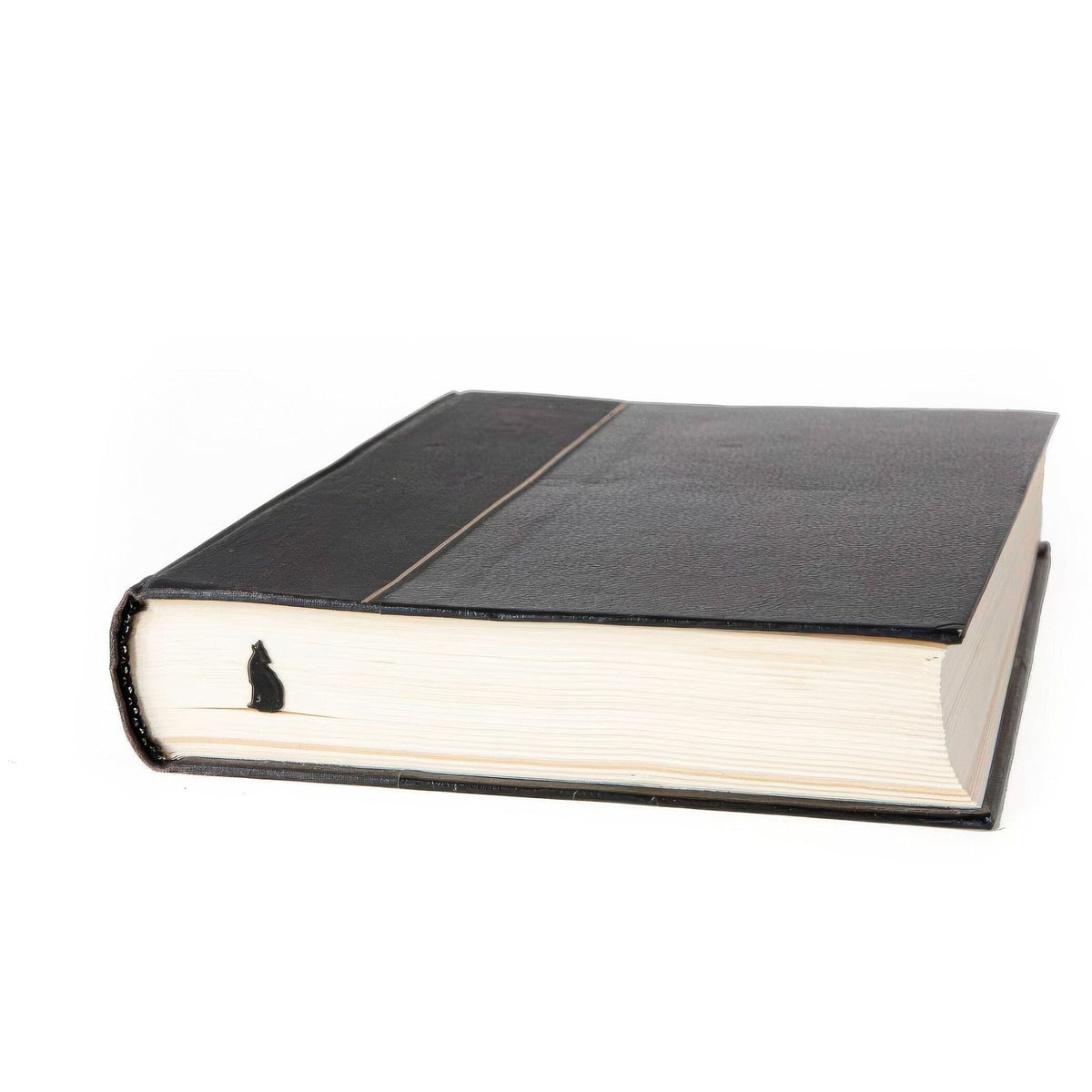 Howling Wolf metal bookmark seen from the edge of a closed book