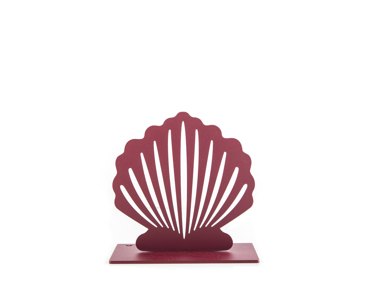 Front view of a single red metal seashell-shaped bookend with a minimalist cutout pattern, placed on a white background.