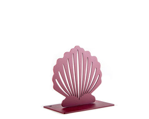 Angled view of a single red metal seashell-shaped bookend with clean cutout lines and a smooth matte finish, photographed on a white background.