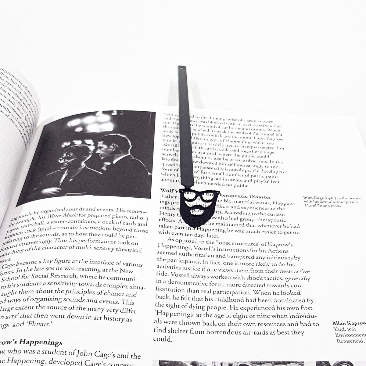 Hipster metal bookmark lying across the pages of an open book