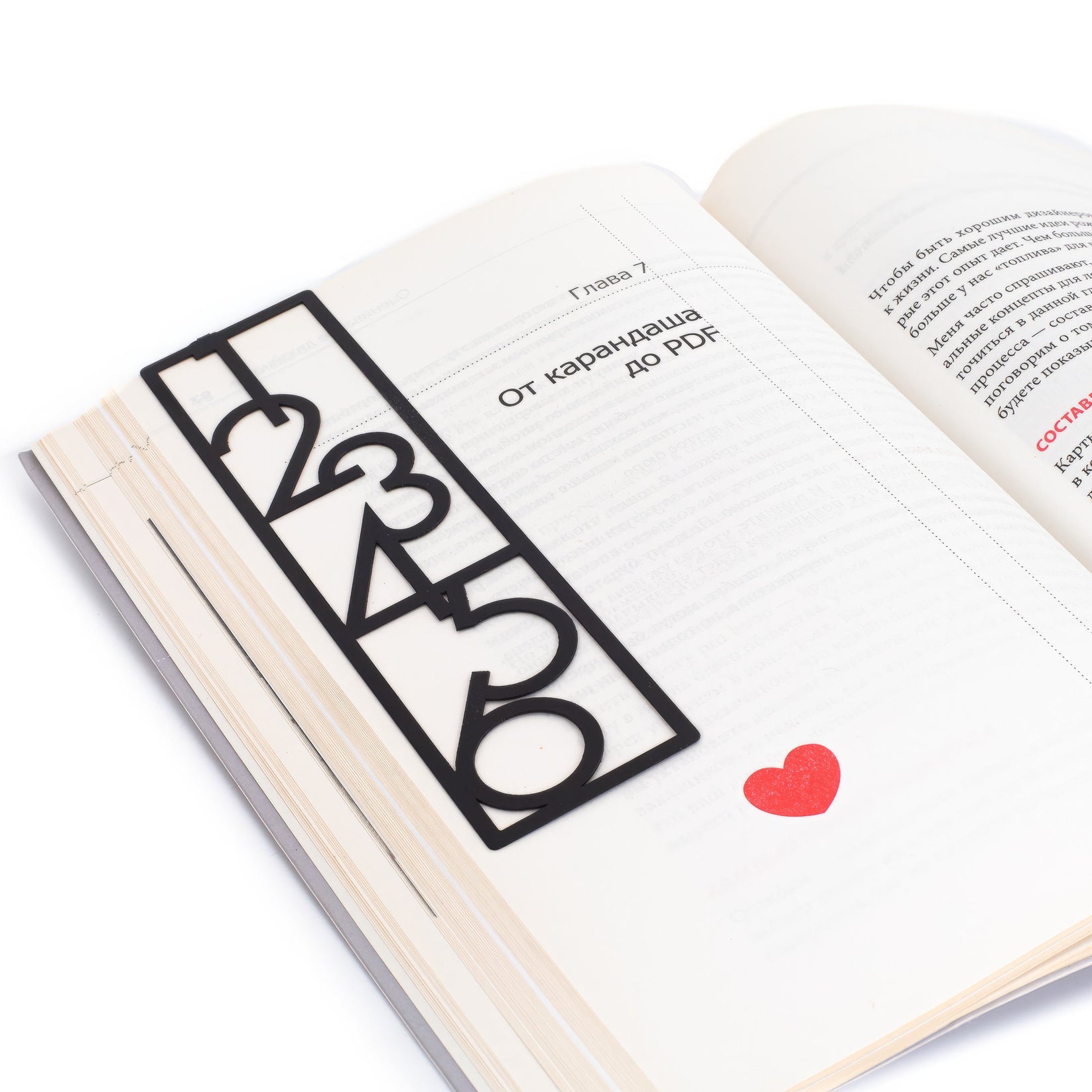 Numbers Bauhaus Style metal bookmark lying across the pages of an open book, view 7