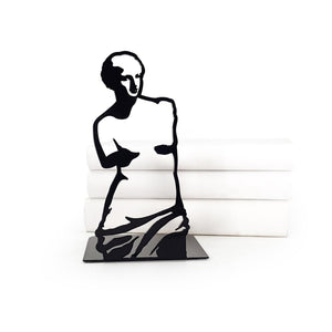 Black metal bookend featuring Venus de Milo silhouette, styled with stacked white books, modern artistic design with classical inspiration.