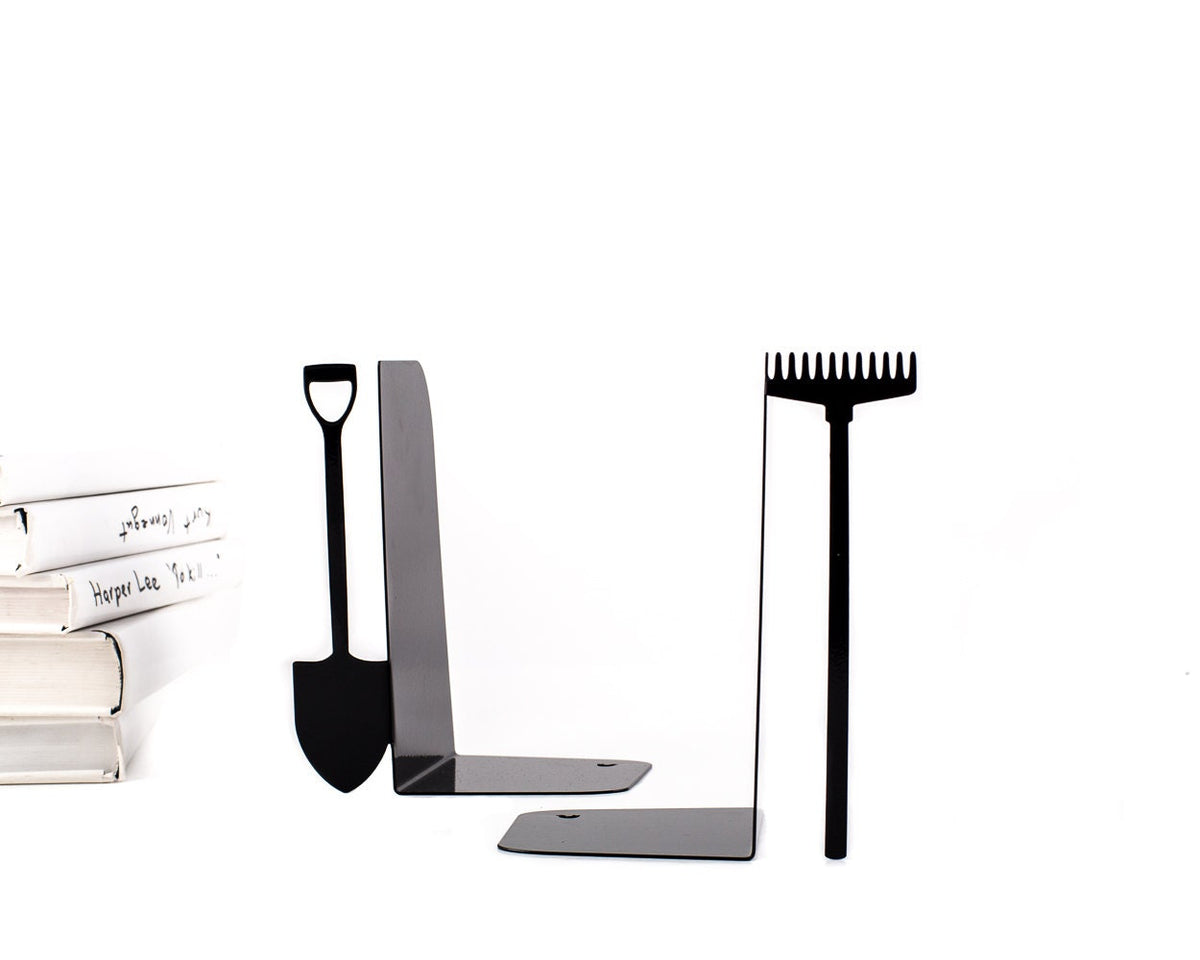 Side view of black metal bookends shaped like garden tools – a shovel and a rake – shown with stacked books. Sturdy and minimalist, ideal for gardeners or anyone who loves playful, nature-inspired shelf decor.